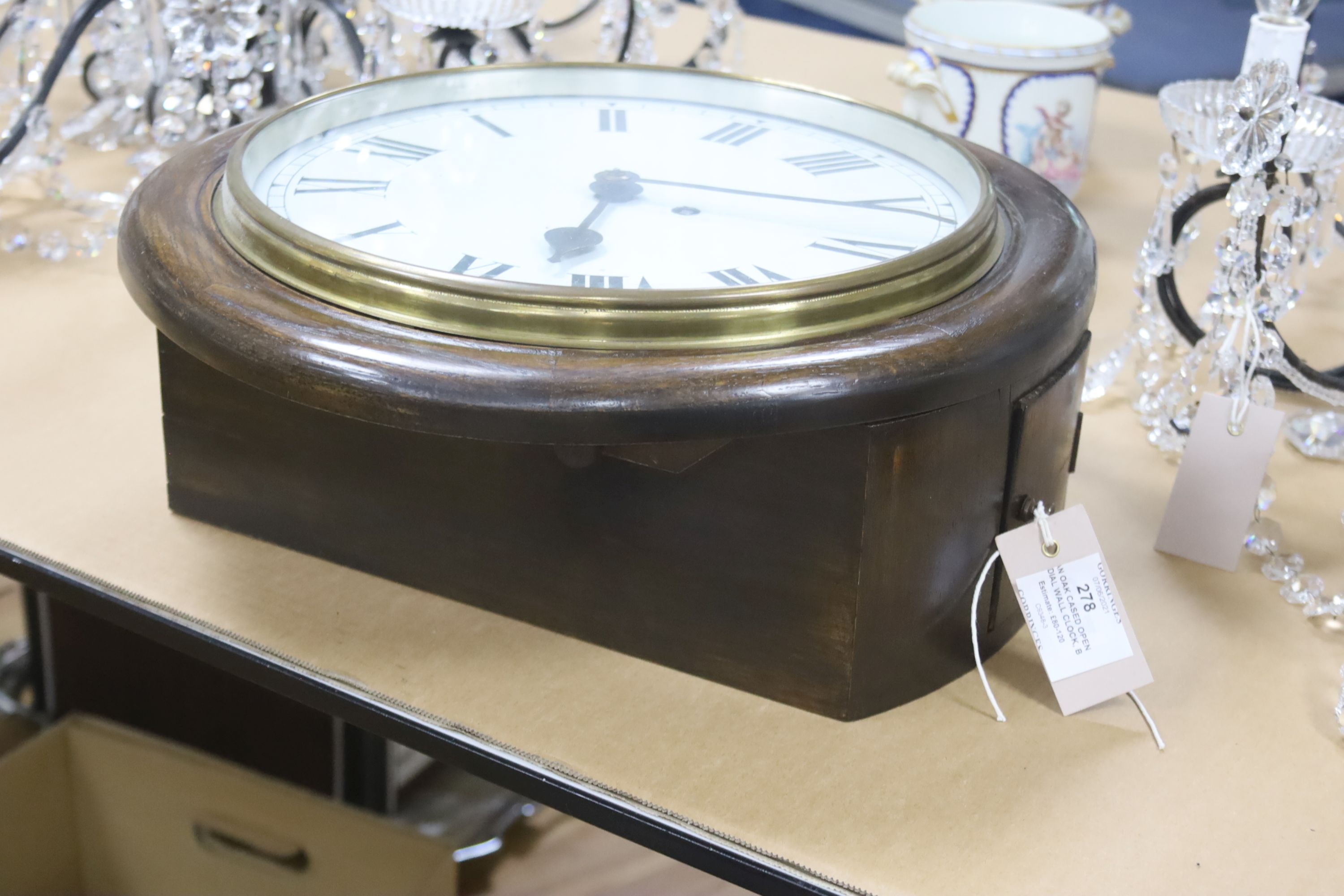 An oak cased single fusee dial wall clock, black Roman numerals on a white 12